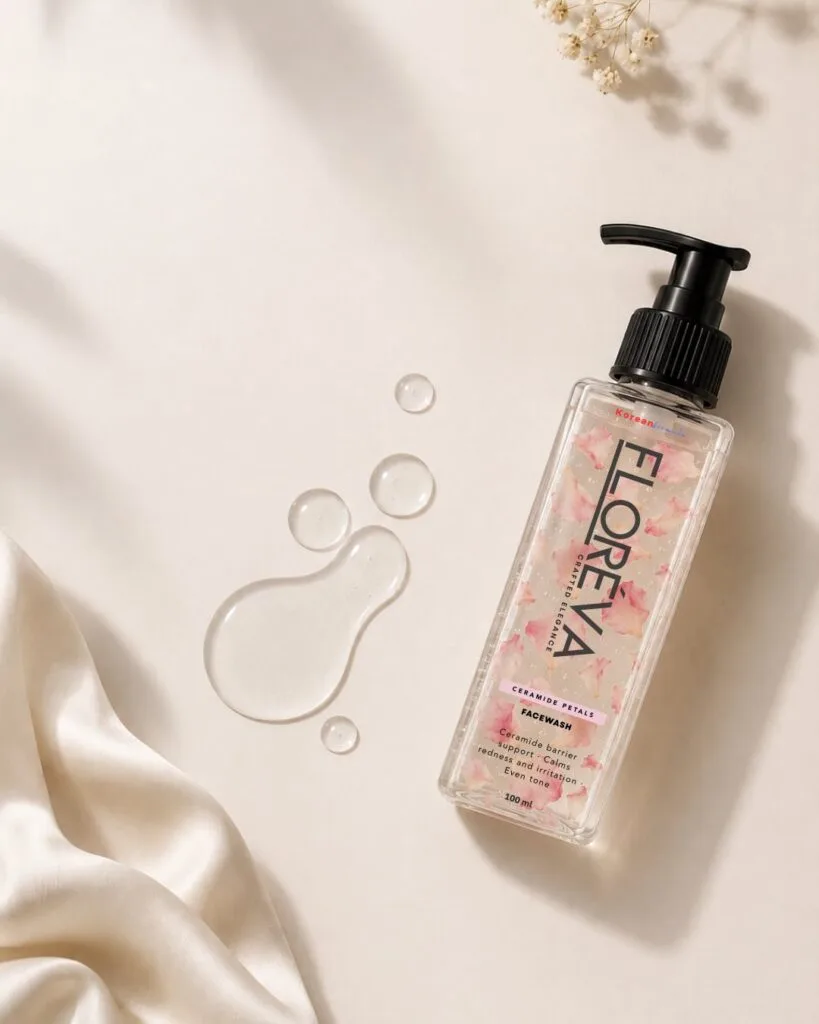 Floreva Ceramide Petal Face Wash flat lay on cream silk with droplets of the clear gel