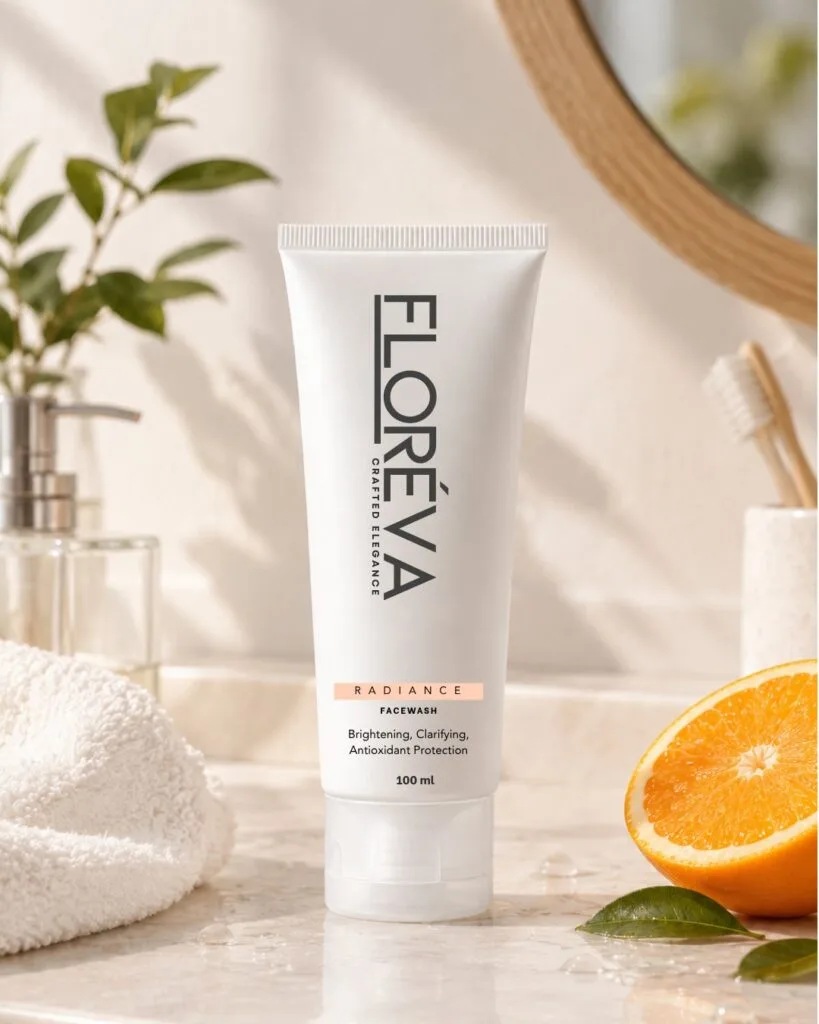 Floreva Vitamin C Facewash on a marble bathroom counter in morning light beside a fresh orange